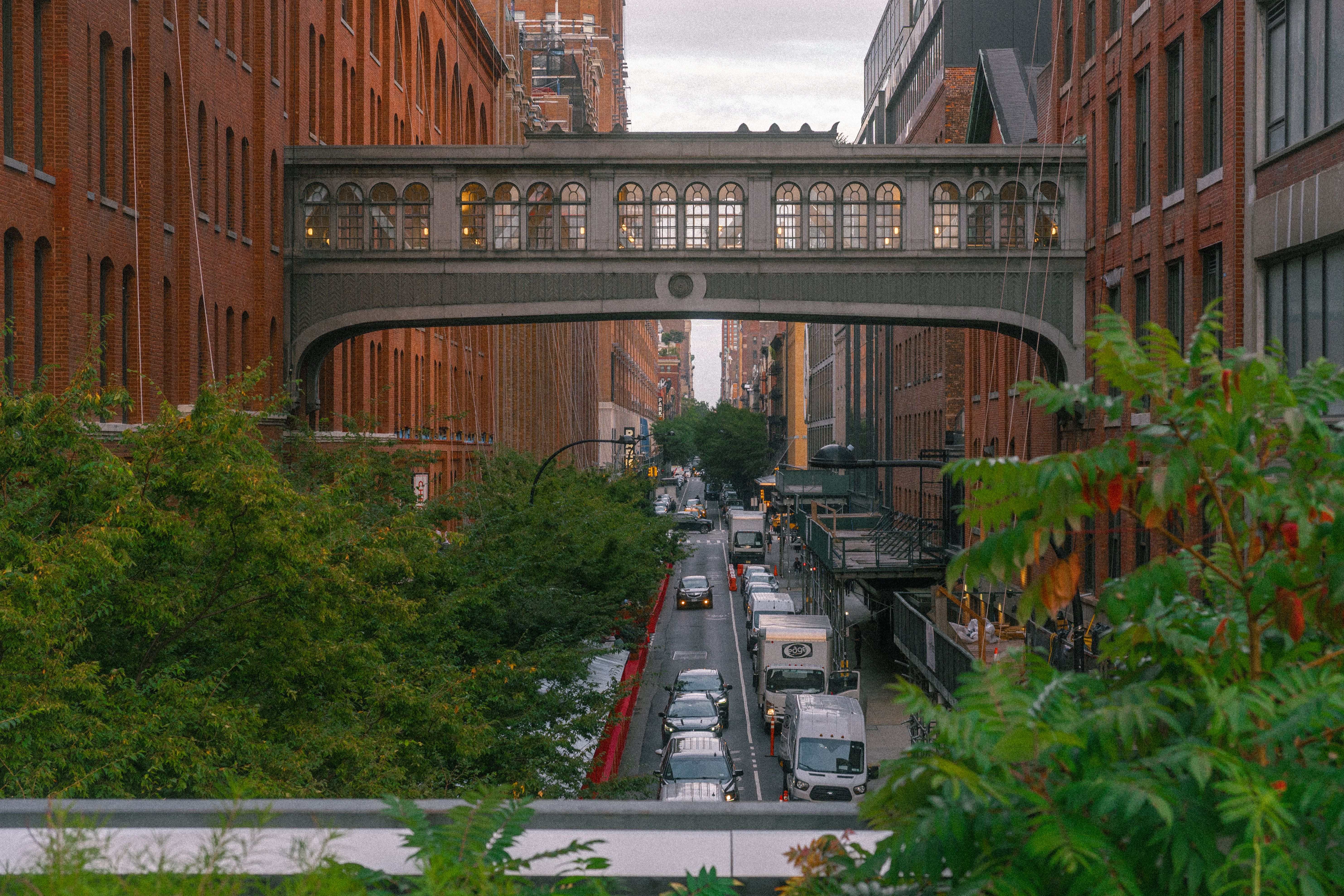 View of Chelsea's High Line elevated park with historic brick buildings and city street below