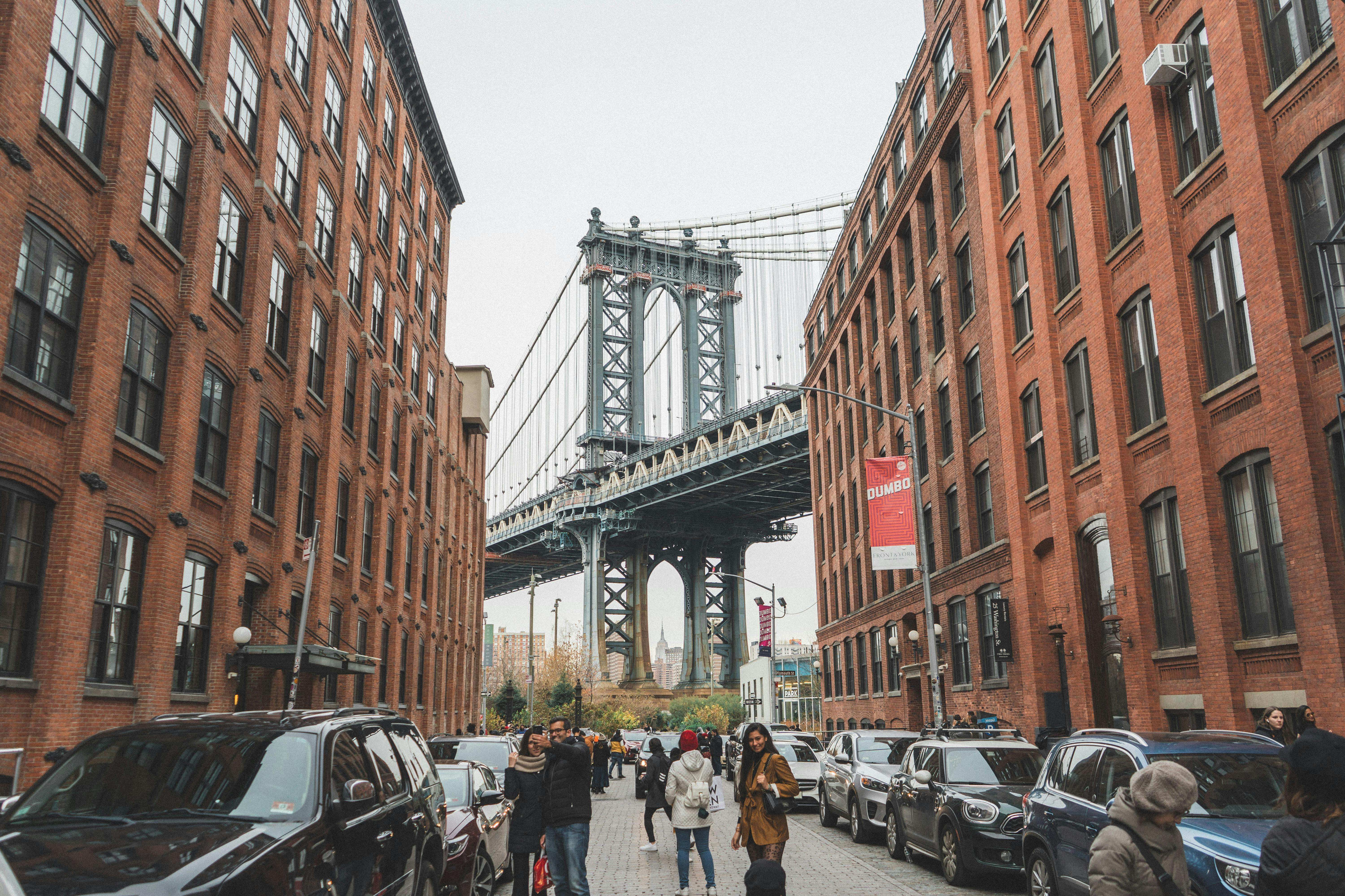 Iconic DUMBO view of Manhattan Bridge framed between brick warehouse buildings on Washington Street